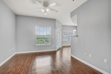 Unfurnished living room featuring a ceiling fan, 