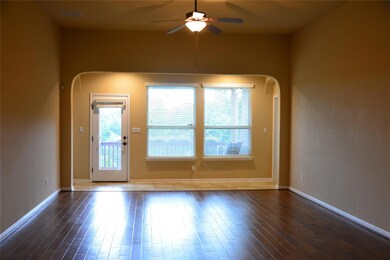 Spare room with a ceiling fan, arched walkways, a