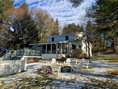 Large side yard with a natural stone fire pit.  No