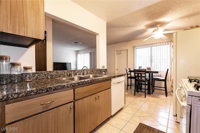 Kitchen featuring white appliances, a sink, a text