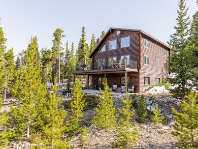 Rear view of house featuring a patio and a deck