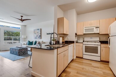 Kitchen with white appliances, light brown cabine