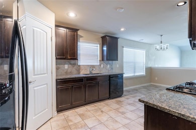 Kitchen with hanging light fixtures, decorative ba