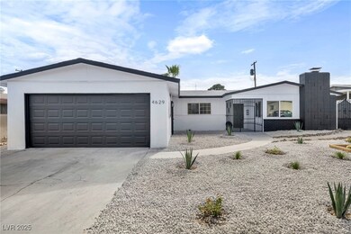 View of front of home featuring a garage and drive