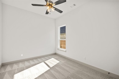 Unfurnished room with carpet floors and a ceiling fan