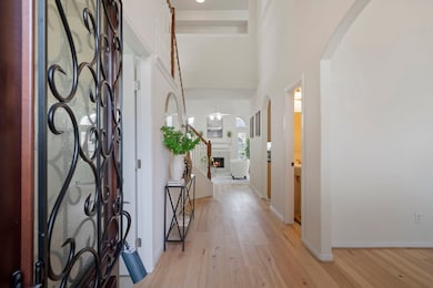 and two-story entry with elegant wrought iron door