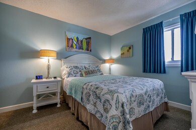 Bedroom featuring carpet and a textured ceiling