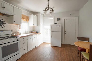 Kitchen featuring white appliances, under cabinet