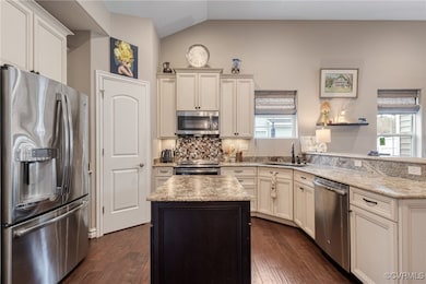 Kitchen with dark wood-style floors, appliances wi