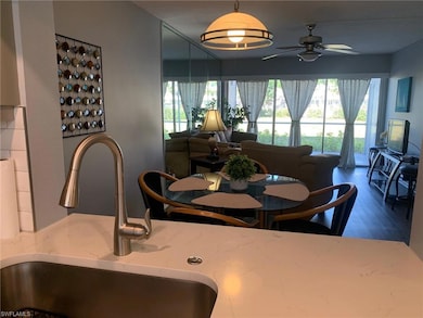 Dining area featuring ceiling fan, sink, and vinyl