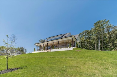 Rear view of property featuring a porch and a yard