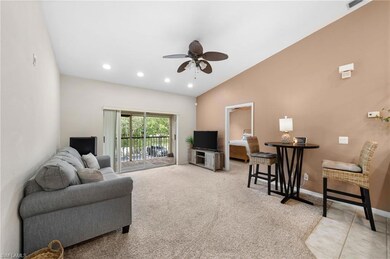 Living room with ceiling fan, light carpet, and va