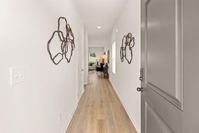 Corridor featuring light wood-style flooring and recessed lighting