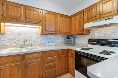 Kitchen with light countertops, under cabinet rang