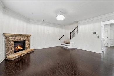 Unfurnished living room with stairway, crown moldi