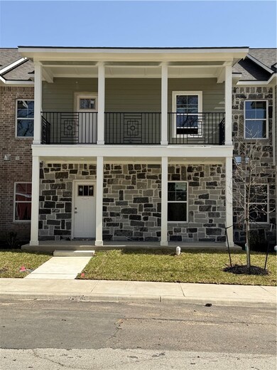 View of front of house with stone siding