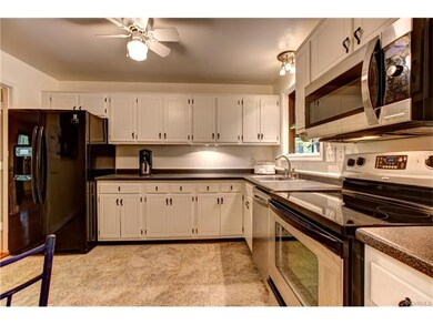 Bright kitchen with white cabinets and stainless s