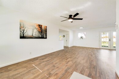 Unfurnished living room with ceiling fan, wood-typ
