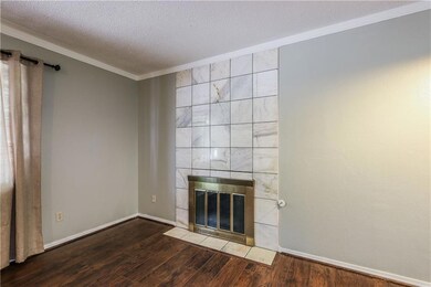 Unfurnished living room with a tiled fireplace, cr