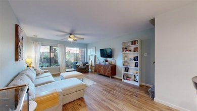 Living room featuring built in features, light woo
