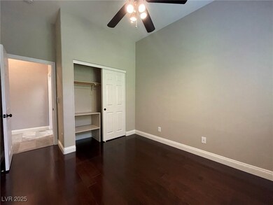 Unfurnished bedroom with dark wood-style floors, b