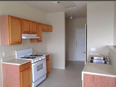 Kitchen featuring gas range gas stove, a sink, un