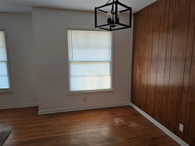 Unfurnished dining area featuring dark wood-type f