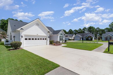 Ranch-style home with a front lawn and a garage