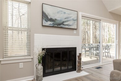 Living room featuring visible vents, a fireplace w
