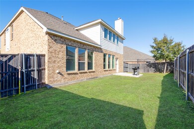 Back of house with a patio area and a lawn
