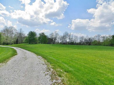Land/Lot. View of driveway from Road, Pole Barn is beyond the trees.