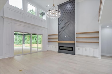 Unfurnished living room featuring a large fireplac