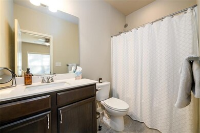 Bathroom featuring visible vents, ceiling fan, toi