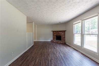 Unfurnished living room with baseboards, a firepla