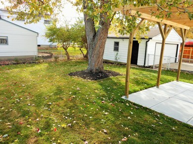 Fenced in backyard with patio
