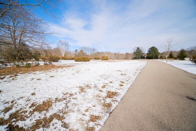 Paved driveway leading to land