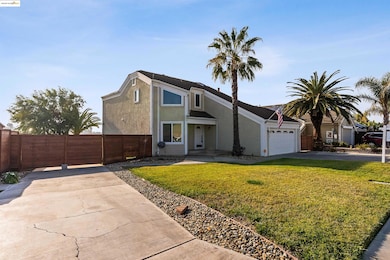 View of front of home with concrete driveway, stucco siding, and an attached garage