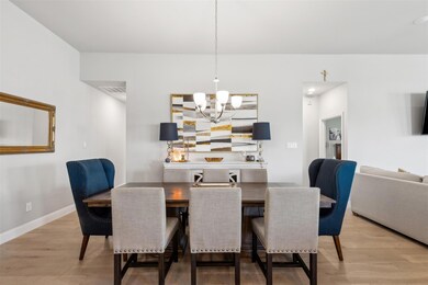 Dining space featuring a chandelier and light hard