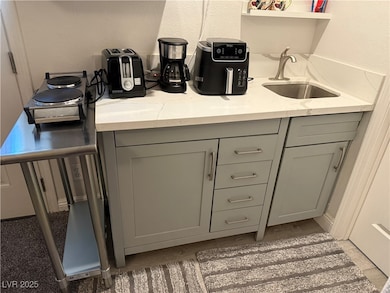 Bar with a textured wall and a sink