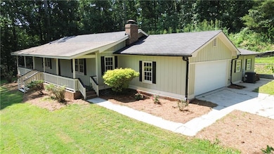 Ranch-style house with an attached garage, a chimney, a porch, concrete driveway, and a front yard