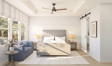 Primary suite with tray ceiling and decorative feature wall