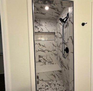 Bathroom with a marble finish shower