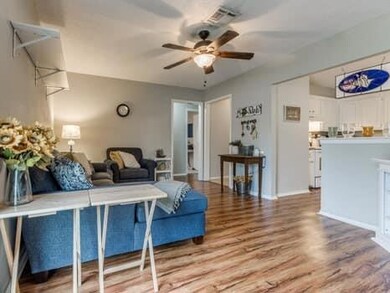 Living room featuring ceiling fan and light hardwood / wood-style floors