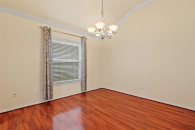 The dining room has tapered ceilings, crown moldin