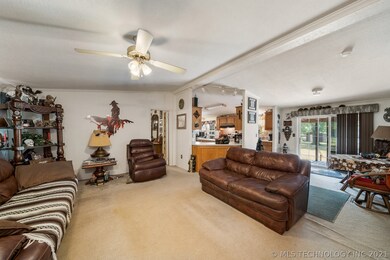 living room looking into kitchen a back deck doors