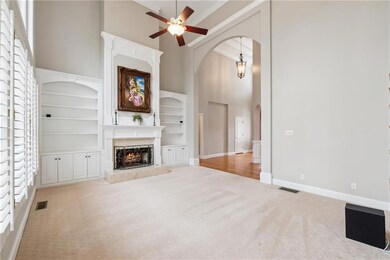 Unfurnished living room with a towering ceiling, a