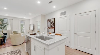 Kitchen with light hardwood / wood-style floors, s