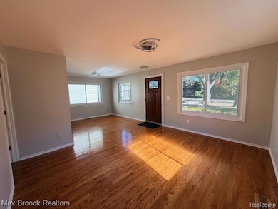 Entryway featuring wood finished floors and baseboards