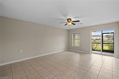 Spare room featuring ceiling fan and light tile patterned floors