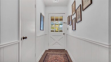 Doorway to outside with ornamental molding and dar
